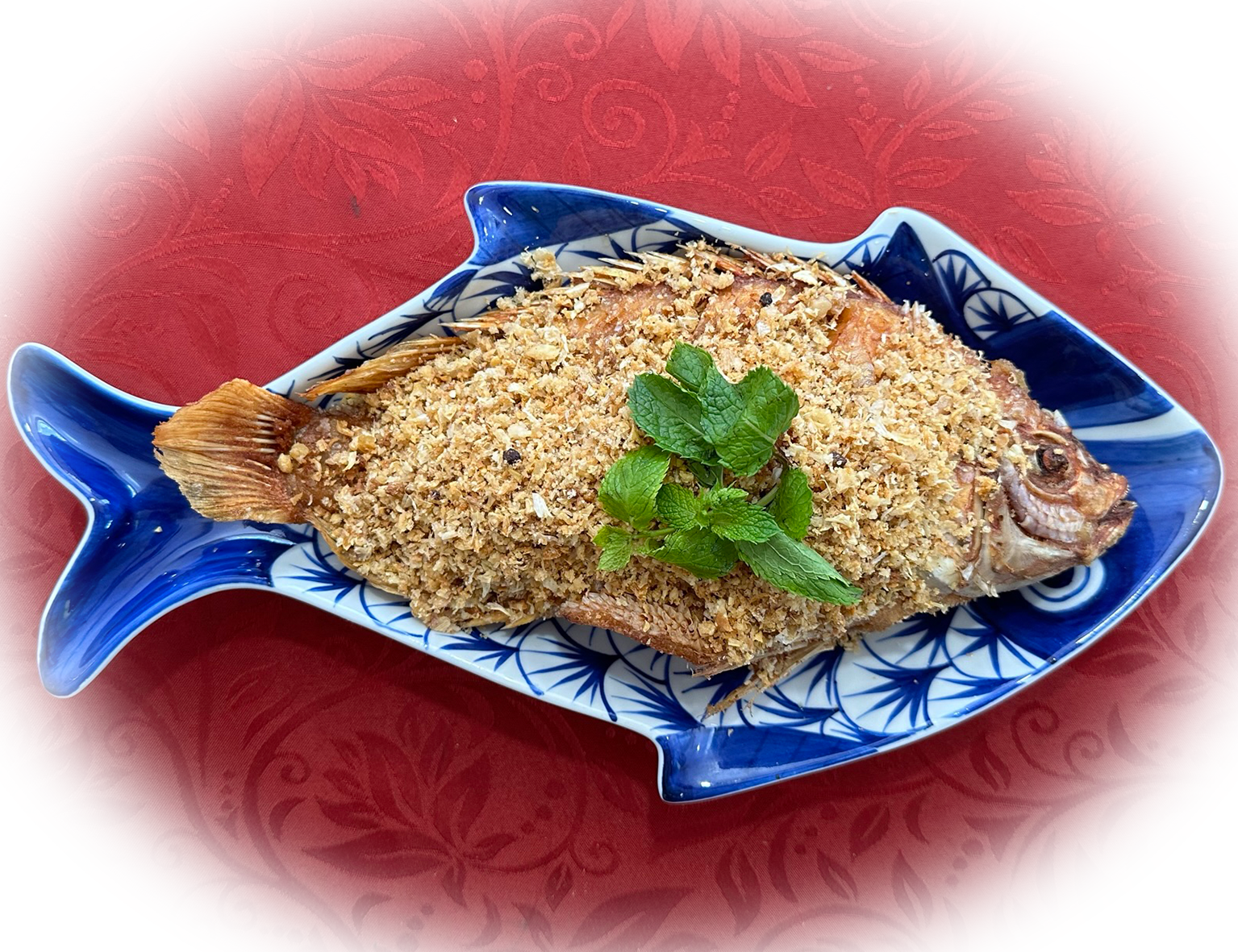 "Pla Thod Kra Tiam Prik Tai" ist ein thailändisches Gericht, das frittierten Fisch mit Knoblauch und