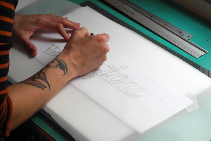 Skizzieren eines handgezeichneten Logo Designs von einer Schriftenmalerin